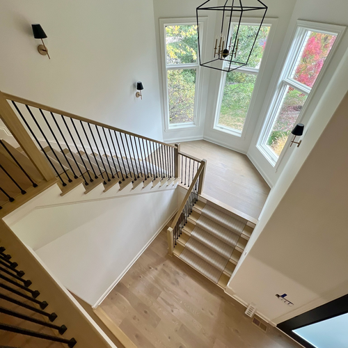 Elegant staircase renovation with tile risers in Central Indiana